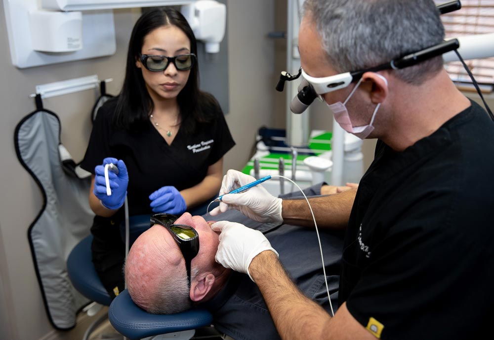 the staff at Northern Virginia Periodontics during a laser dentistry procedure treating gum disease