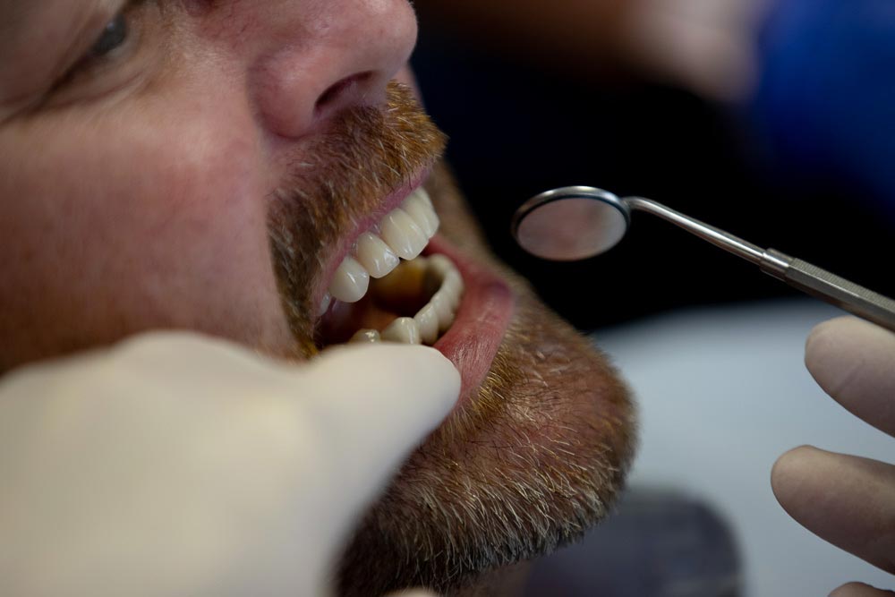 a patient during his dental exam