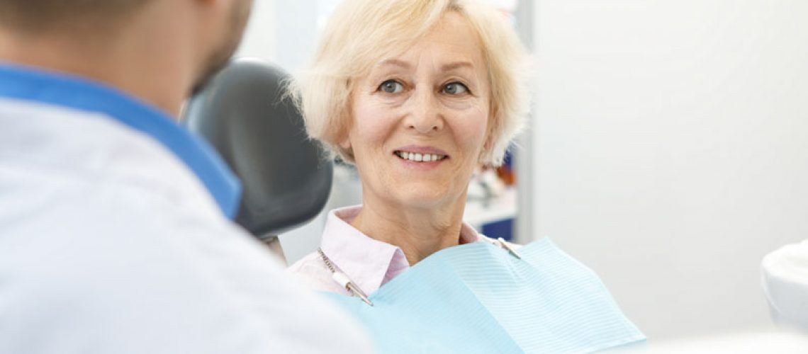 Dental Patient Being Taught About Dental Implants By Her Doctor